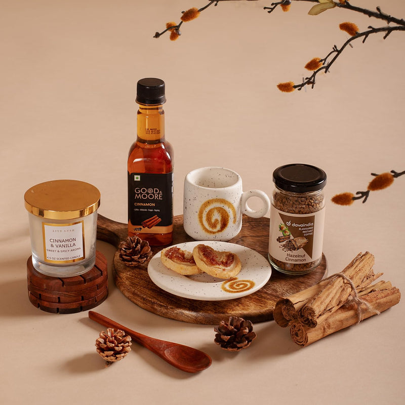 The Knot Company Cinnamon Collection Gift Set of 7 Assorted Items | Cinnamon Candle, Sticks, Syrup, Cookies, Hazelnut Cinnamon Coffee, Cup & Saucer and Wooden Spoon